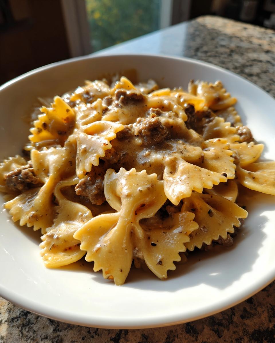 Close-up of creamy beef pasta made with farfalle (bowtie) noodles coated in a rich sauce.