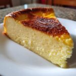 A close-up of a perfectly baked slice of silky egg custard with a deeply caramelized top.