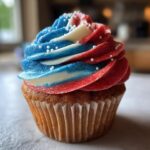 Close-up of a cupcake with patriotic red, white, and blue frosting swirls, perfect for International Nurses Day cupcakes.